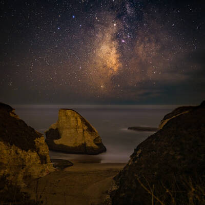Photo of Milky Way setting in the ocean at Shark Fin Cove, California. Autumn. Early night.