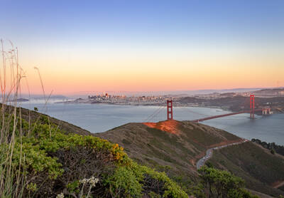 Photo of Golden Gate Bridge from Slacker Hill in Marin County. Sunset. Summer.
