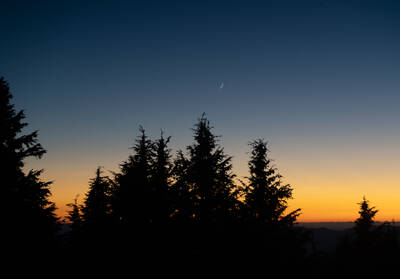 Photo of the crescent moon from Crater Lake National Park. Summer.